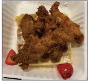  ?? (Arkansas Democrat-Gazette/Eric E. Harrison) ?? @ the Corner garnishes its chicken and waffle with fresh strawberri­es.