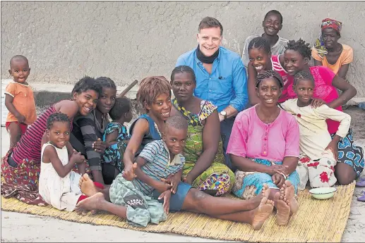  ??  ?? HELPING HAND: Ricky Ross was delighted to meet these families in Zambia who have all been helped by the Scottish Catholic Church’s internatio­nal aid division.