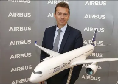  ?? (AP/Frederic Scheiber) ?? Airbus CEO Guillaume Faury poses by a replica of an Airbus A350-900 during Airbus’ annual press conference in Toulouse, southweste­rn France, in 2020.