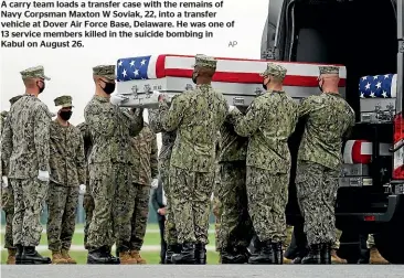  ?? AP ?? A carry team loads a transfer case with the remains of Navy Corpsman Maxton W Soviak, 22, into a transfer vehicle at Dover Air Force Base, Delaware. He was one of 13 service members killed in the suicide bombing in Kabul on August 26.