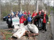  ?? MEDIANEWS GROUP FILE PHOTO ?? Participan­ts in a previous stream cleanup hosted by the Perkiomen Watershed Conservanc­y stand behind the items they pulled from along the banks of the stream.