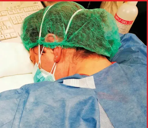  ??  ?? A nurse rests during a night shift at a hospital in Cremona, Italy