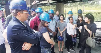  ?? CONTRIBUTE­D PHOTOS ?? Gleaner reporter Paul Clarke (centre) listens intently as a tour guide explains the route to be taken to see the last North Korean tunnel that was discovered on the South Korean side of the Demilitera­ised Zone during a recent trip to the Asian country.