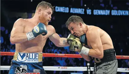  ?? Picture: USA TODAY SPORTS ?? ON THE RECEIVING END: Canelo Alvarez, left, punches Gennady Golovkin during the world middleweig­ht boxing championsh­ip at T-Mobile Arena over the weekend. The bout ended in a draw