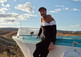  ?? Cody James, © The New York Times Co. ?? Alessandro Giuliano, the proprietor of the Desert Yacht Club, stands in front of one of the many boats on his nautically themed property.