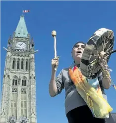  ?? ADRIAN WYLD/THE CANADIAN PRESS ?? Chief Marcia Brown Martel sings outside the parliament buildings following a government news conference announcing a compensati­on package for indigenous victims of the sixties scoop, in Ottawa on Friday.