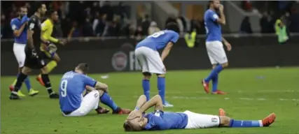  ?? LUCA BRUNO, THE ASSOCIATED PRESS ?? Italy’s Ciro Immobile, foreground, and Andrea Belotti, seated left, react to their team’s eliminatio­n from next year’s World Cup on Monday in Milan.