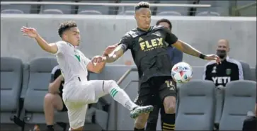  ?? Ringo H.W. Chiu Associated Press ?? Mark-Anthony Kaye, right, battled Austin FC’s Daniel Pereira Gil for the ball.