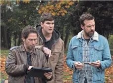  ?? CHRIS HELCERMANA­S-BENGE ?? Tim Blake Nelson, Austin Stowell and Jason Sudeikis watch as Hathaway controls a monster across the globe in Asia.
