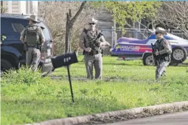  ??  ?? Law enforcemen­t officers secure the neighborho­od at Walnut and 2nd Street in Pflugervil­le, Texas, on Wednesday, where Austin, Texas, bombing suspect Mark Anthony Conditt lived.| TOM REEL/ THE SAN ANTONIO EXPRESS- NEWS VIA AP