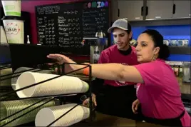  ?? ?? Isaiah Flores, left, and Macarena Schrodt make drinks at the Tonantzin Casa de Cafe on Saturday.