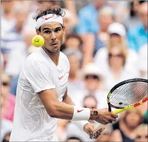  ?? CP PHOTO ?? Rafael Nadal of Spain returns the ball to Novak Djokovic of Serbia in the men’s singles semifinal match at the Wimbledon Tennis Championsh­ips, in London, Saturday, July 14. Nadal has won the Rogers Cup three times, but last year he was upset by...