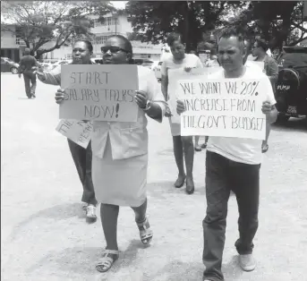  ??  ?? Protestors on the march around the campus’ pond