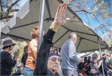  ?? ROBERTO E. ROSALES/JOURNAL ?? ABOVE: Joe Romero, a Bataan Death March survivor, waves to the crowd as he is introduced at a ceremony marking the 75th anniversar­y of the start of the Bataan Death March. Romero was a prisoner of war from April 1942 until September 1945, when World...
