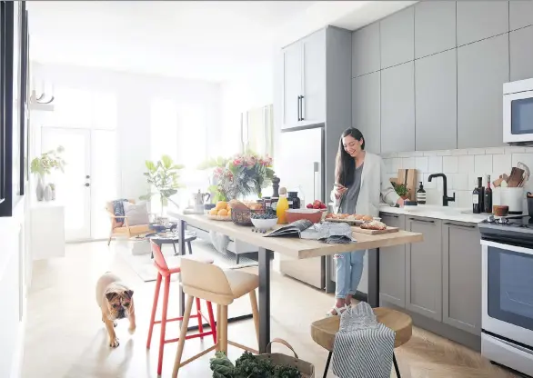  ??  ?? Kitchens feature white cast-iron single-bowl sinks, matte-black hardware and faucets, under-cabinet task lights and Whirlpool appliance packages — under a 10-foot ceiling.