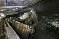  ?? Provided by Consol Energy Inc. ?? A machine cuts slabs of coal inside Consol Energy's Bailey Mine in southweste­rn Pennsylvan­ia. Two unions representi­ng hundreds of miners in the Pittsburgh region sued the Trump administra­tion on Tuesday, demanding federal workplace health officials authorize stronger COVID-19 protection­s for the country’s mines.