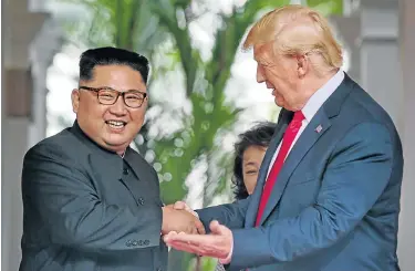  ?? Picture: REUTERS ?? KIM GETS HIS PHOTO OP: US President Donald Trump meets North Korean leader Kim Jong-un at the Capella Hotel on Sentosa island in Singapore yesterday