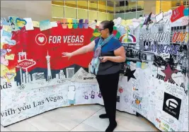  ?? Michael Quine ?? Las Vegas Review-journal @Vegas88s Ally Haynes-hamblen, cultural affairs director for the city of Las Vegas, points out some of the comments on the Hearts for Vegas display Tuesday on the second floor of Las Vegas City Hall.