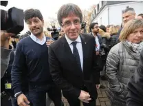  ?? PICTURE: AFP ?? Deposed Catalan leader Carles Puigdemont (centre) leaves after posing with his fellow candidates after a press conference in Oostkamp