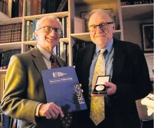  ??  ?? Prizegivin­g Roger Crofts, chair of RSGS (left) with Perth Academy teacher, Kenneth Maclean holding the prestigiou­s Tivy Education Medal presented to him for his services to teaching geography