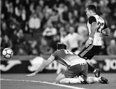  ??  ?? Valencia’s Spanish forward Santiago Mina Lorenzo (R) shoots to score a goal during the Spanish league football match RCD Espanyol vs Valencia CF at he RCDE Stadium in Cornella de Llobregat on November 19, 2017. - AFP photo