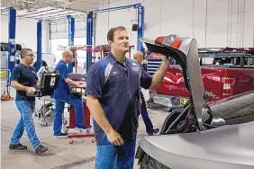  ??  ?? Certified body technician Ryan Clevenger works on a vehicle at Car Crafters on July 27 in Albuquerqu­e.