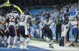  ?? DUANE BURLESON THE ASSOCIATED PRESS ?? Bears celebrate after cornerback Kyle Fuller intercepte­d a pass in the end zone intended for Detroit Lions tight end Michael Roberts during the second half Thursday in Detroit.