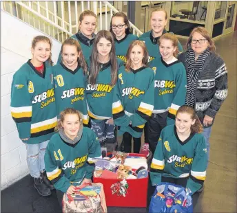  ?? KEVIN ADSHADE/THE NEWS ?? Tearmann House executive director Donna Smith, middle row, far right, is shown with some of the Fundy Highland Bantam AA Subway Selects. In front are Abigail MacKenzie, left, and Ava Gennoe. In middle row from left are: Taylor Long, Olivia Fitt, Kenzie...