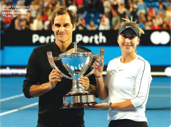  ??  ?? Roger Federer and Belinda Bencic with the Hopman Cup Photo: AP