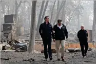  ?? AP FILE PHOTO BY EVAN VUCCI ?? In this 2018 photo, President Donald Trump talks with California Gov.-elect Gavin Newsom, left, as California Gov. Jerry Brown, walks at right during a visit to a neighborho­od destroyed by the Camp wildfire in Paradise, Calif.