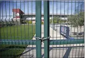  ?? SUE OGROCKI — THE ASSOCIATED PRESS ?? A gate at the Chicago Cubs practice facility at Sloan Park in Mesa, Ariz., is closed and locked Monday, March 16, 2020. The remainder of spring training baseball games have been canceled due to the coronaviru­s.