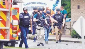  ?? MATT BUTTON / BALTIMORE SUN MEDIA GROUP ?? Police make their way toward the scene of the shooting in Perryman Sept. 20. Snochia Moseley, 26, fatally shot three people and wounded three others before killing herself.