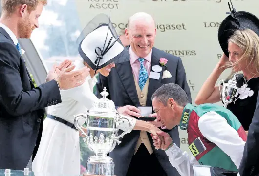  ??  ?? Winning jockey Frankie Dettori cheekily kisses Meghan’s hand yesterday – and left, he gets a finger wag warning from her husband Harry