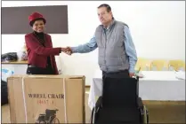  ??  ?? GOOD CAUSE: The Department of Trade and Industry’s deputy director-general Sarah Choane hands over wheelchair­s and other donations to the general manager of Sizanani Children’s Home Carl Busquet.