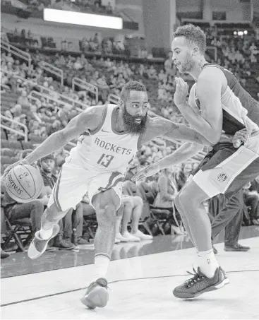  ?? Michael Wyke / Associated Press ?? Guard James Harden, left, and the Rockets looked out of sorts, especially on defense, against guard Kyle Anderson and the Spurs during a 106-97 preseason loss Friday night at Toyota Center.