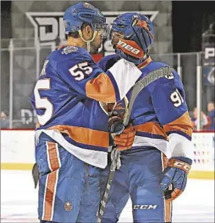  ?? GETTY ?? Johnny Boychuk (l.) celebrates first period goal with John Tavares as Islanders continue offensive roll with big win over L.A. Kings on Thursday in Brooklyn.