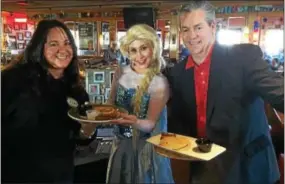  ?? L.A. PARKER - THE TRENTONIAN ?? Miss Ramapo Valley 2017 and Miss New Jersey contestant Lauren Staub (center) flanked by City of Angels members Amy Such (l) and organizati­on co-founder Kevin Meara during COA pancakes fundraiser at Applebee’s in Hamilton.