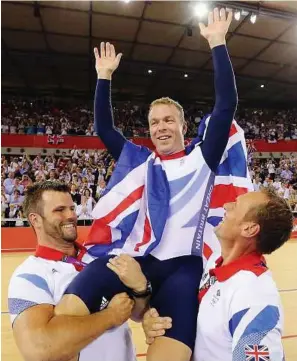  ?? — Reuters ?? A-Hoy there: Britain’s Chris Hoy is carried by officials after he won the keirin on Tuesday.