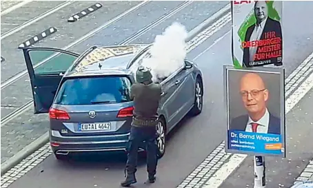  ?? AFP ?? In this screenshot taken from a video by ATV-Studio Halle, a man shoots in the streets of Halle an der Saale, eastern Germany, on Wednesday.