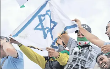  ??  ?? They’re attacking synagogues, too: Rioters in Paris burning the Israeli flag last month.