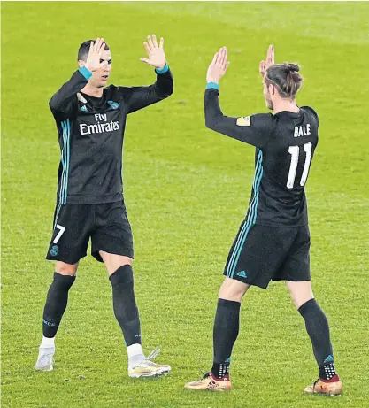  ??  ?? Real Madrid’s Gareth Bale, right, and Cristiano Ronaldo celebrate after the match against Al Jazira.