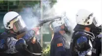  ??  ?? Police in Podgorica, Montenegro fire tear gas to repel 1,500 anti-gay extremists hurling stones and firebombs at the 150 participan­ts in the capitol’s first ever gay pride march. The country hopes to prove it respects minority rights after applying to...