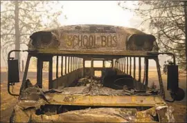  ?? Kent Nishimura Los Angeles Times ?? A BURNED-OUT school bus sits last week near Concow Reservoir, once a popular gathering spot for families from the nearby mountain town of the same name.