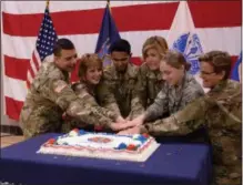  ?? PHOTO PROVIDED ?? Airman First Class Emily Irish of Porter Corners, second from right, helped cut the cake for the National Guard’s 382nd birthday celebratio­n in Latham on Thursday.