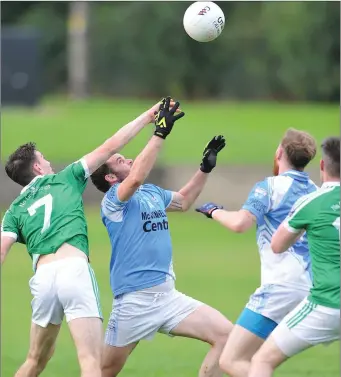  ??  ?? Jack Traynor denies Hugh McGinn clean possession during their Division 1 clash on Sunday.