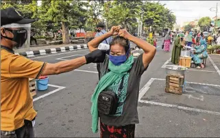  ?? ASSOCIATED PRESS ?? With Indonesia’s overall caseload on the rise, Jakarta’s governor has eased restrictio­ns. But experts warn that reopening too soon could cause a second wave in the city of 11 million.