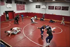  ?? CHRIS CHRISTO — BOSTON HERALD ?? On Wednesday, Arlington High wrestlers practice at their home, the Pit. It will be a sad day for coach Kevin Cummings when The Pit is taken down after the regular season.