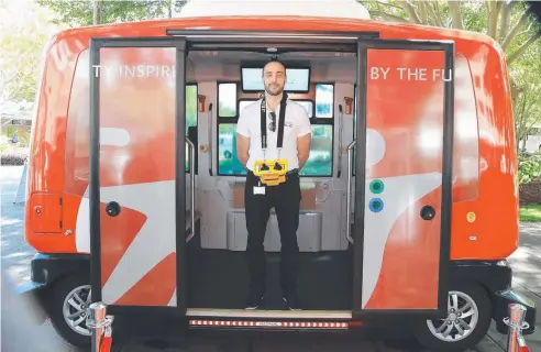  ?? Picture: JUSTIN BRIERTY ?? ALL ABOARD: Programmer of the shuttle, Arnaud Lago, waits for customers who were invited to hitch a ride in the self-driving vehicle after it arrived in Cairns for a trial run.