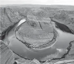  ?? Ross D. Franklin, Associated Press file ?? The Colorado River flows around breathtaki­ng Horseshoe Bend in the Glen Canyon National Recreation Area near Page, Ariz. Western states have agreed to begin taking less water from the drought-stricken river.