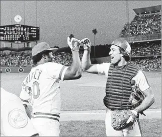  ?? Associated Press ?? KEN GRIFFEY SR. of the Reds, named most valuable player of the 1980 game, gets some love from Montreal’s Gary Carter after the National League defeated the American League 4-2.